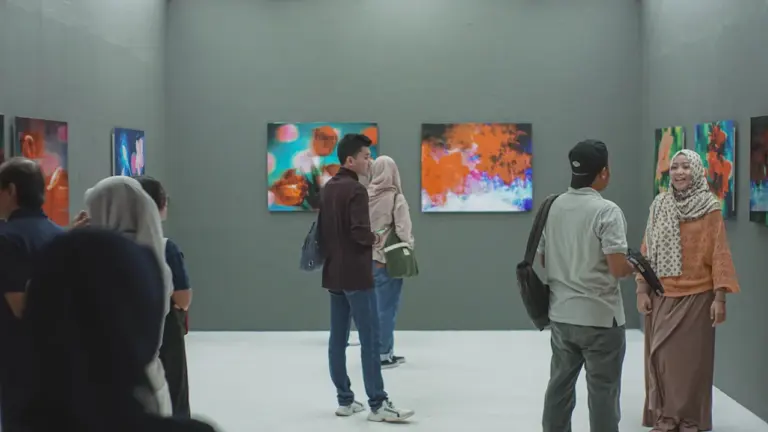 Eine Besucherin betrachtet ein großes impressionistisches Gemälde in einer hellen Museumshalle.