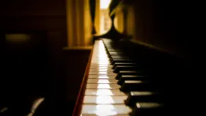 Ein klassisches Klavier in einem stimmungsvoll beleuchteten Raum für den Stummfilmabend in Paderborn.
